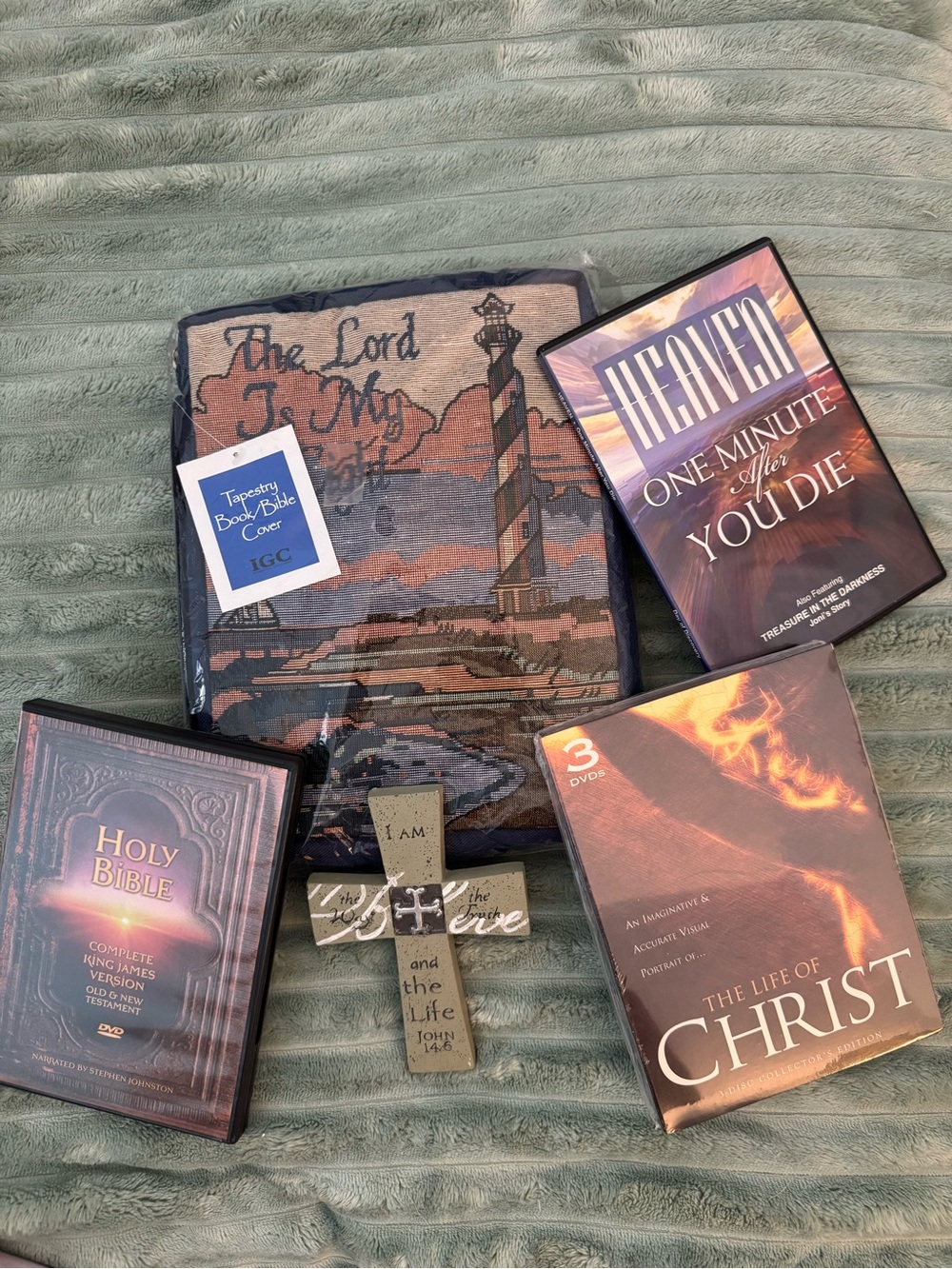 bible cover, three DVDs, and cross